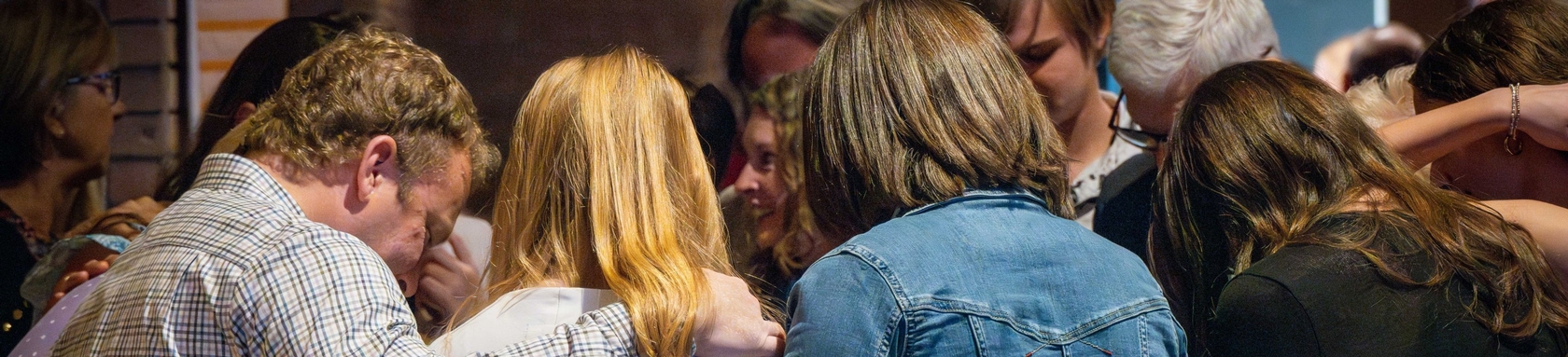 A family hugs their 8th grade daughter