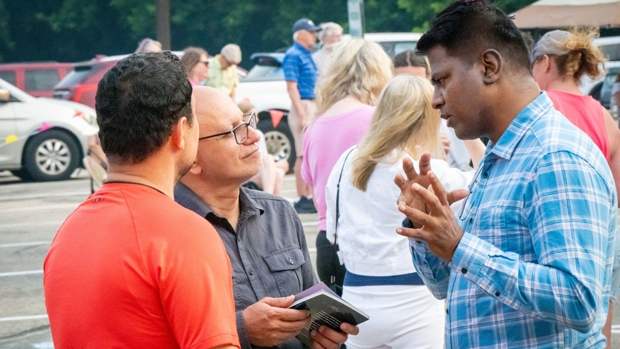 Three men talk at the Cross View Block Party. Three men talk at the Cross View Block Party.