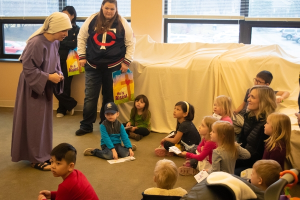 Easter characters talking with a group of children