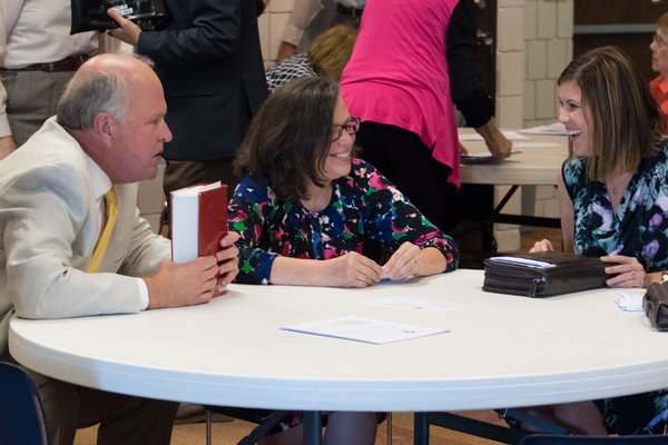 Three adults laughing during Bible study