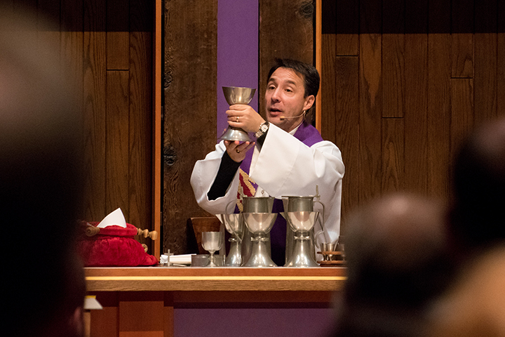 Pastor Wheeler holding the communion chalice.