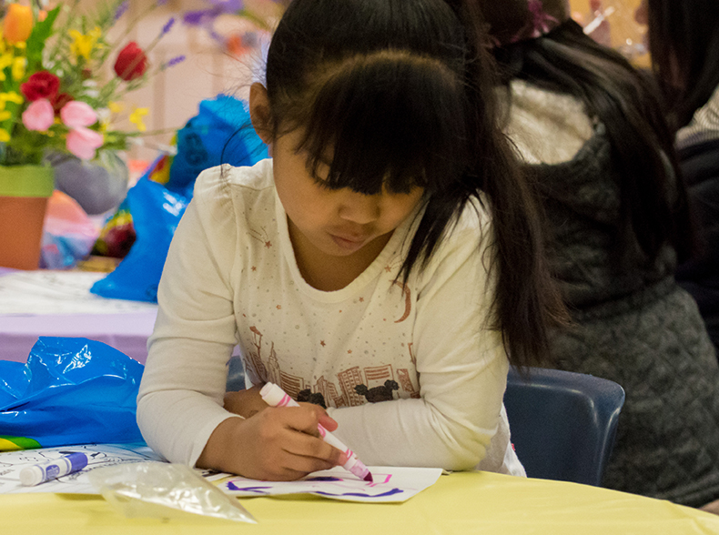 A young girl drawing.